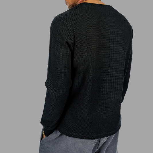 Black full-hand T-shirt, laid flat to display its design and comfortable fit.