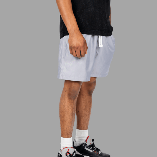 Close-up of black sports shorts with white stripes on the sides, showcasing lightweight and breathable fabric designed for active wear